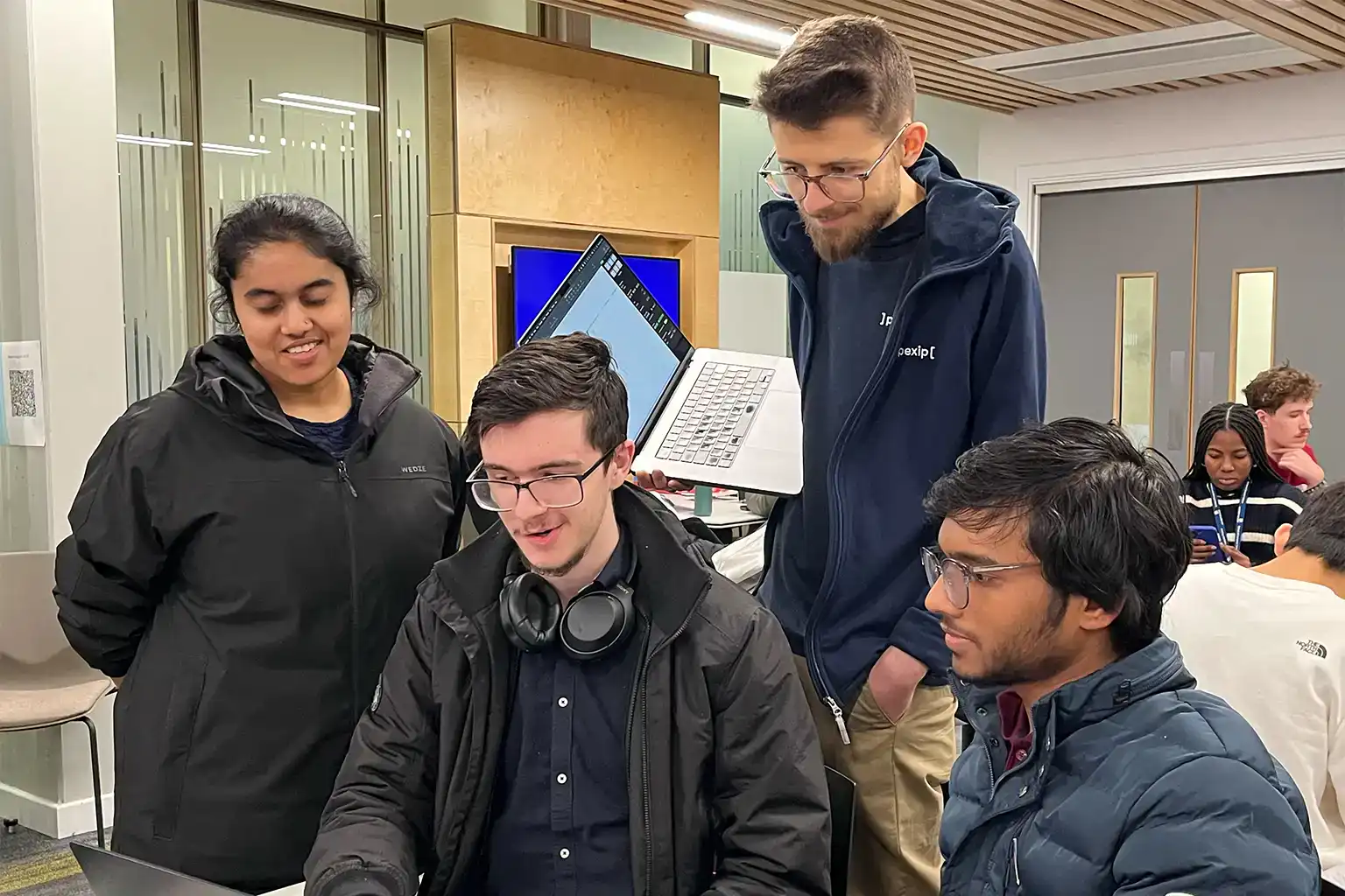 Attendees showing their work to a judge at LeedsHack 2025