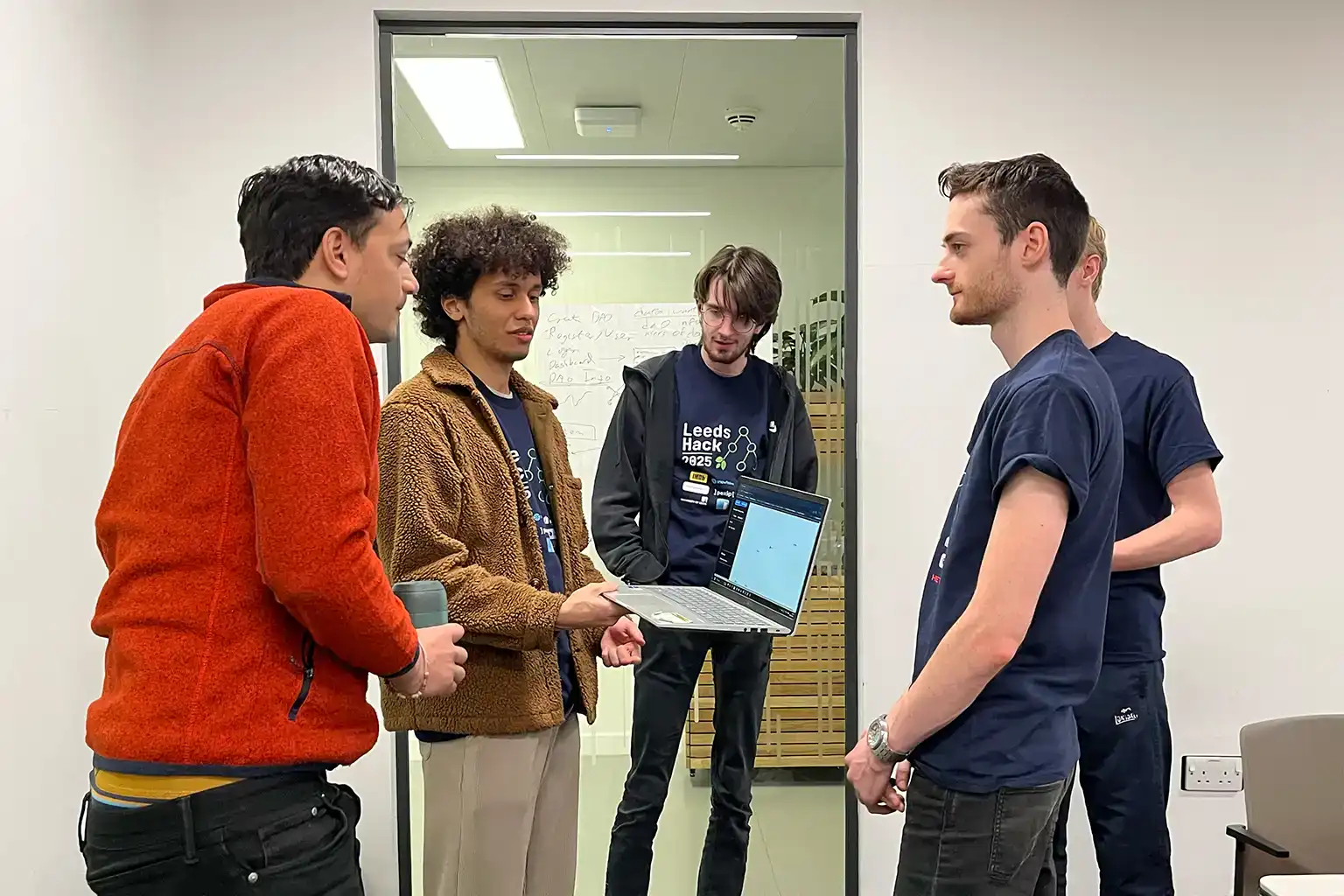 Attendees showing their work to a judge at LeedsHack 2025